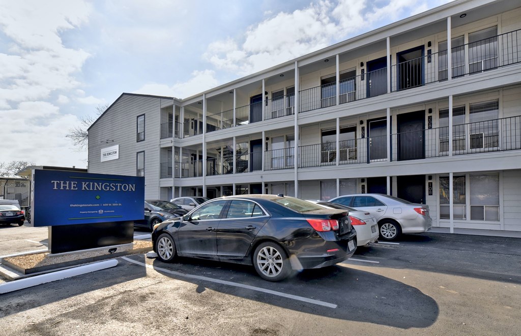 an office building with cars parked in front of it