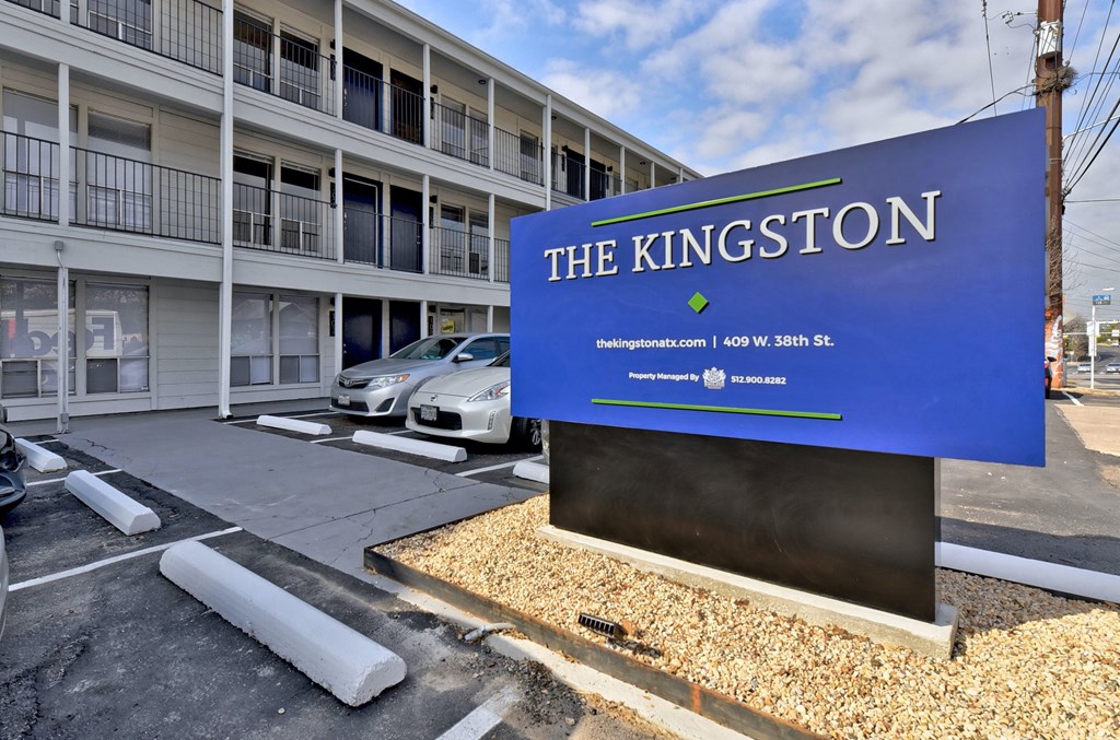 a blue sign in a parking lot
