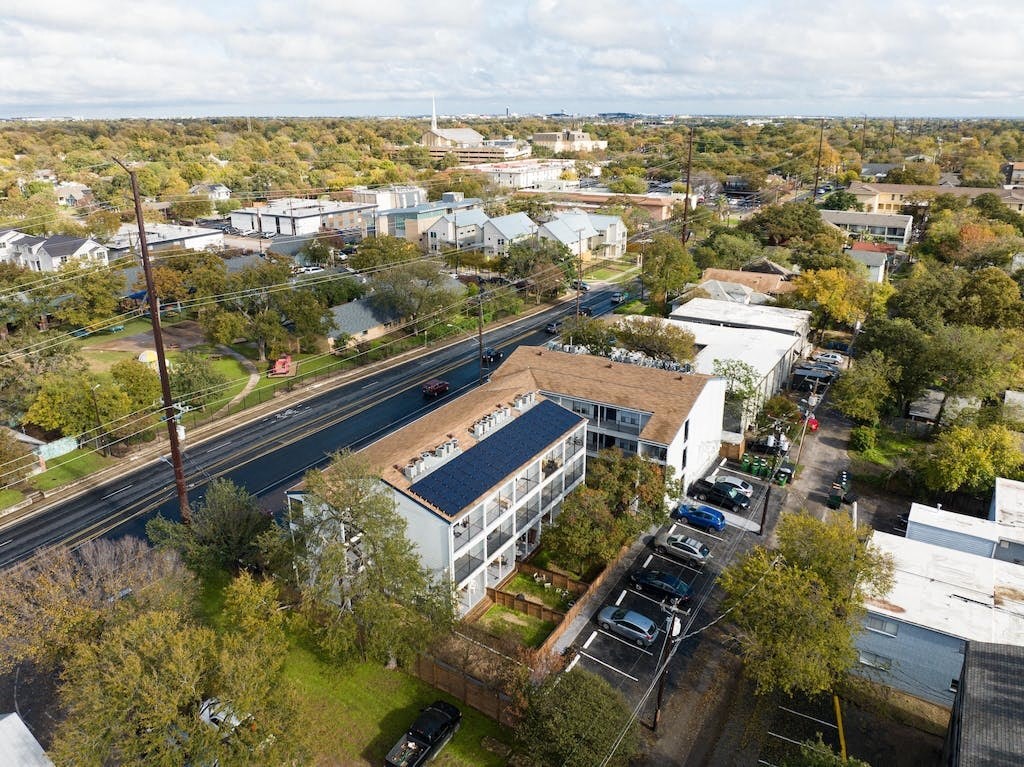 an aerial view of a building next to a road