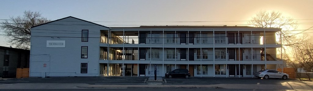 a white building with cars parked in front of it