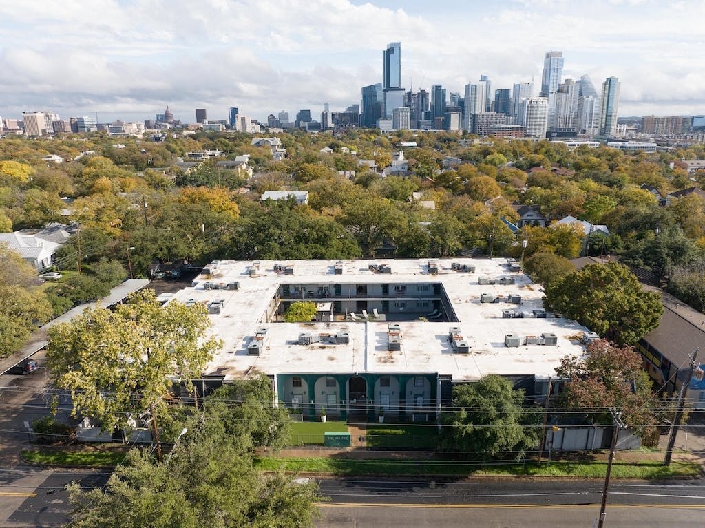 an aerial view of the building with the skyline in the background