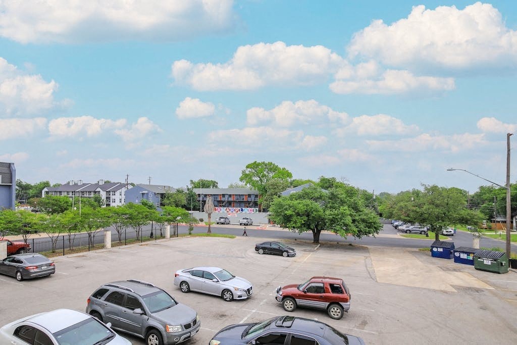 a parking lot filled with cars and trees