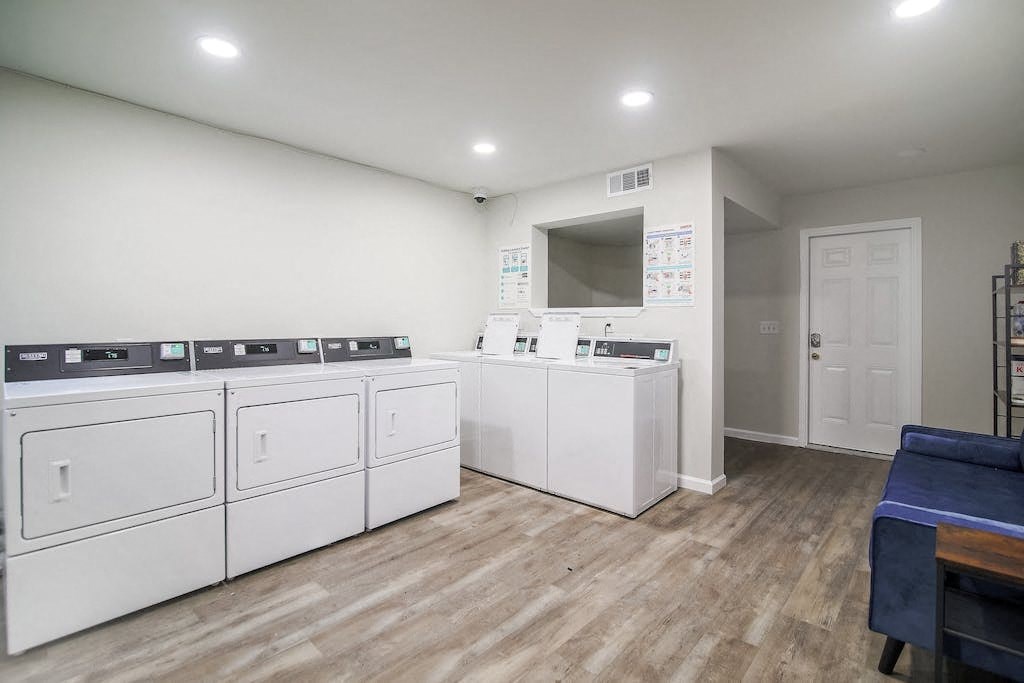a laundry room with washers and dryers and a door