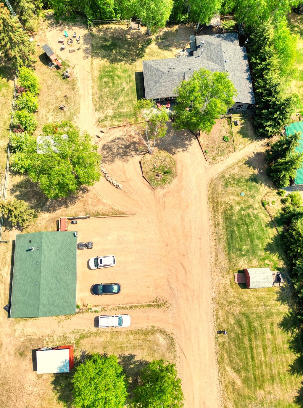 arial view of a farm with a field and a barn and trees and a