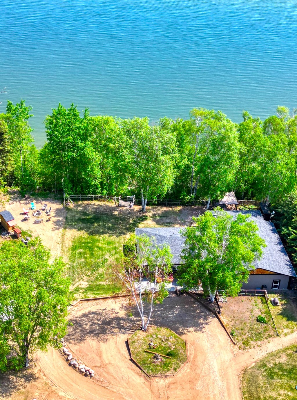 an aerial view of a campsite with trees and the water