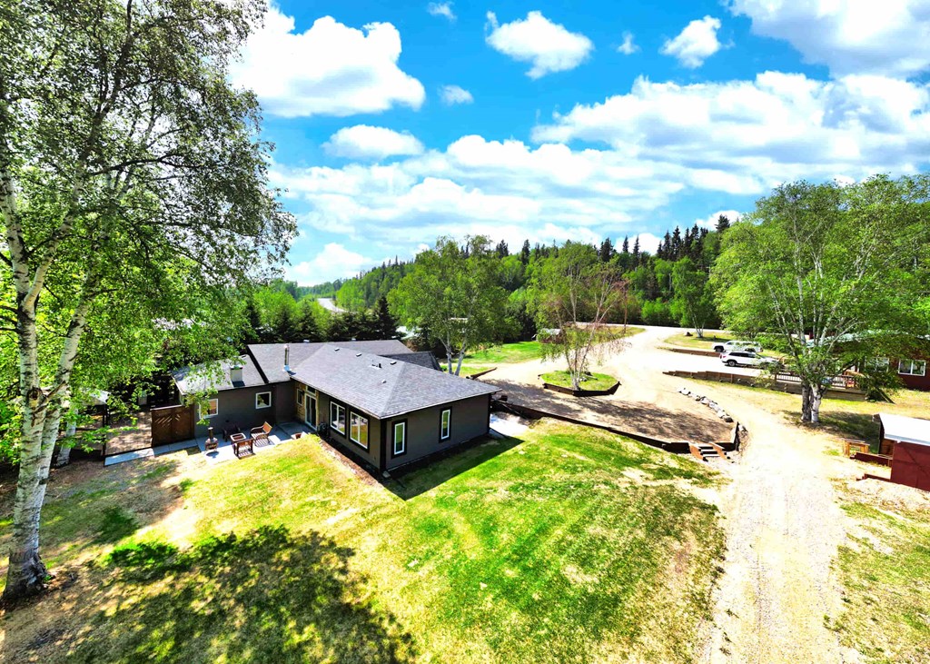 a view from above of a house and a dirt road