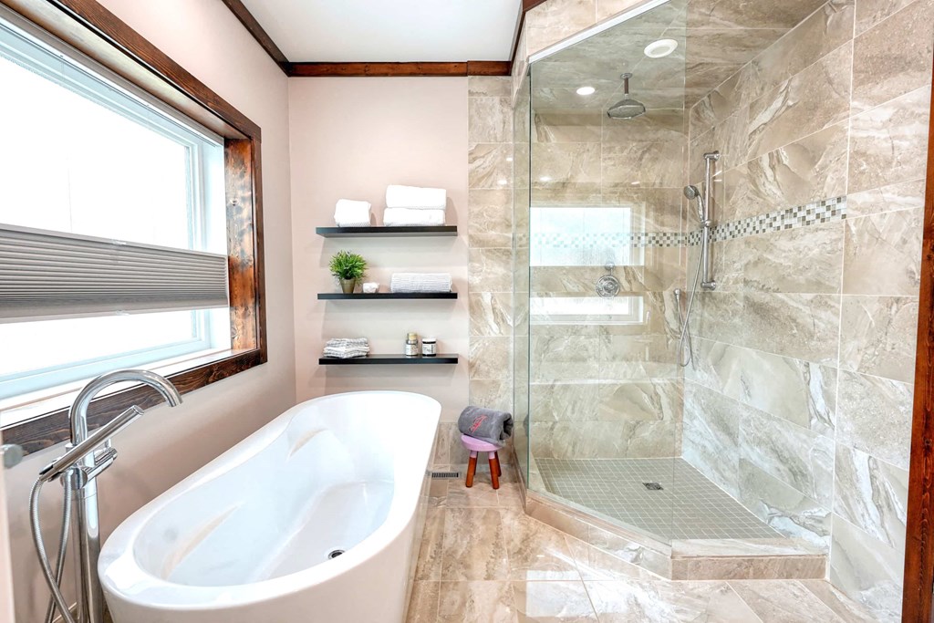 a large bathroom with a tub and a shower