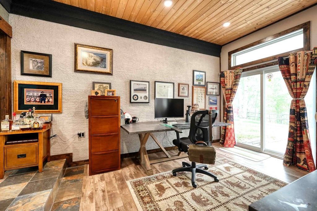 a home office with a desk and a window