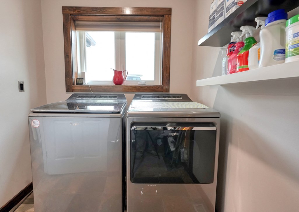 a washer and dryer in a laundry room with a window