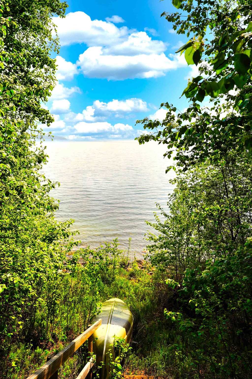 a canoe sitting on the shore of a lake