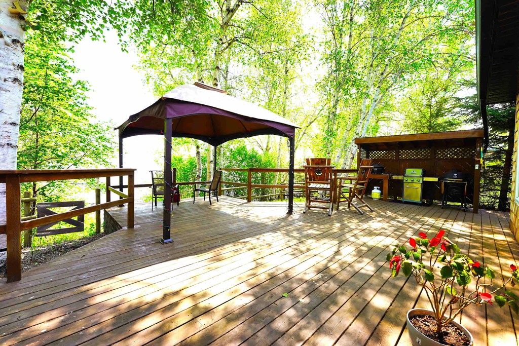 a large deck with a gazebo and tables on it