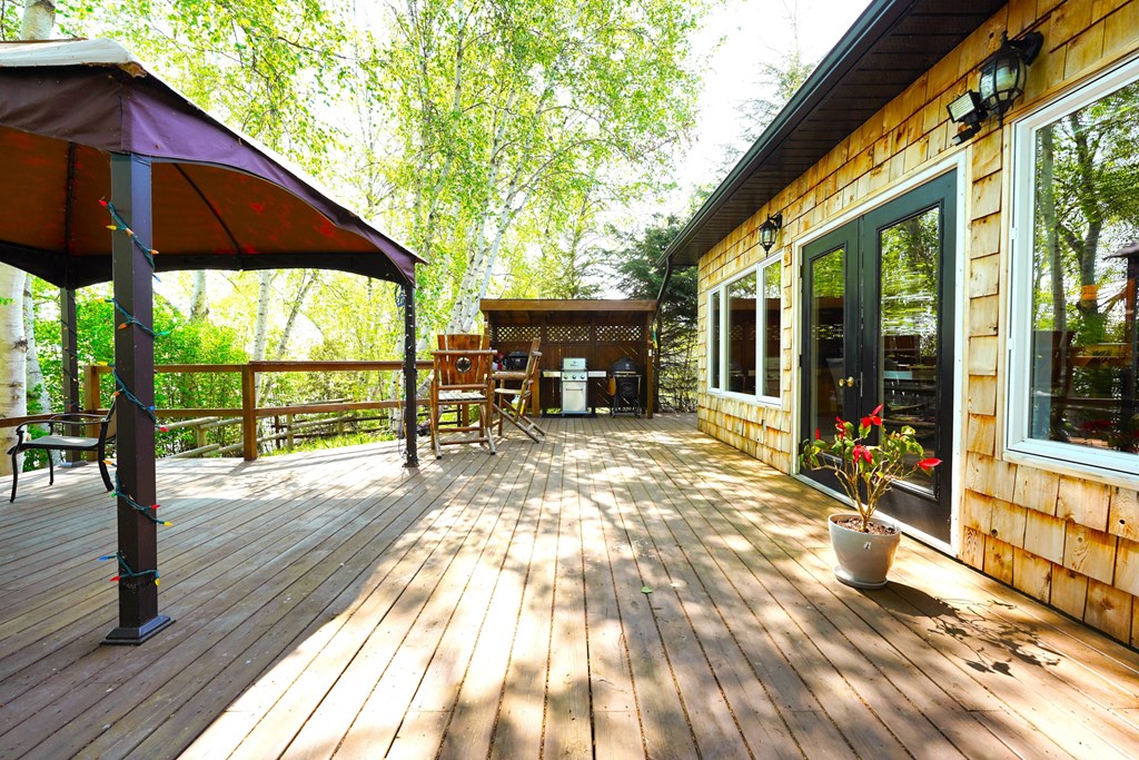 a large deck with a picnic table and umbrella on it