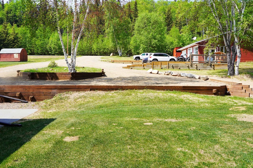 a large yard with a wooden deck and a dock