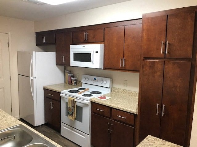 a kitchen with a stove microwave and refrigerator