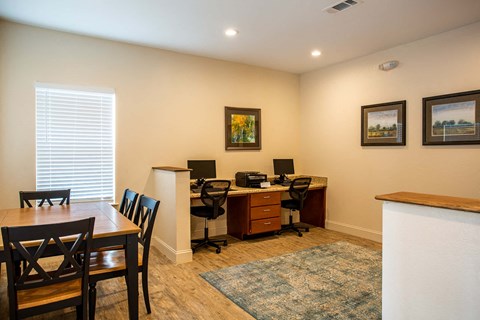 a home office with a table and chairs