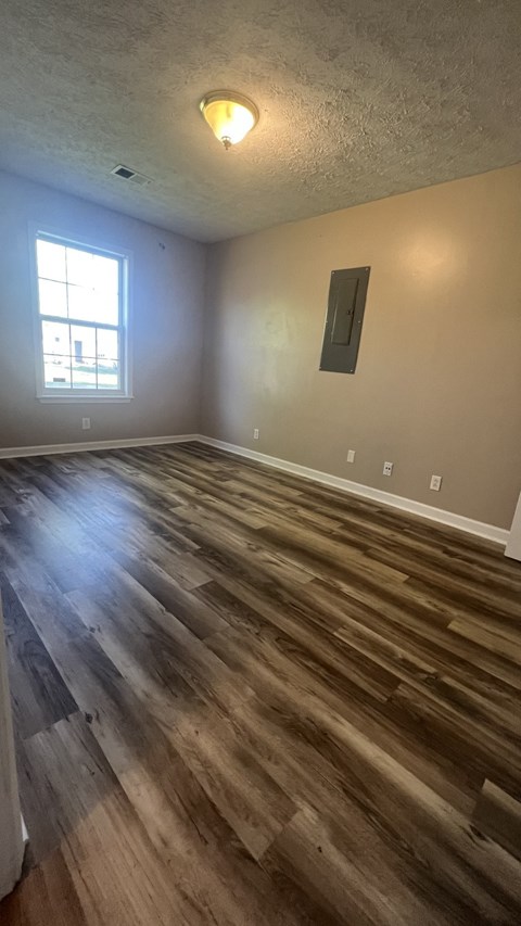 a living room with wood floors and a window