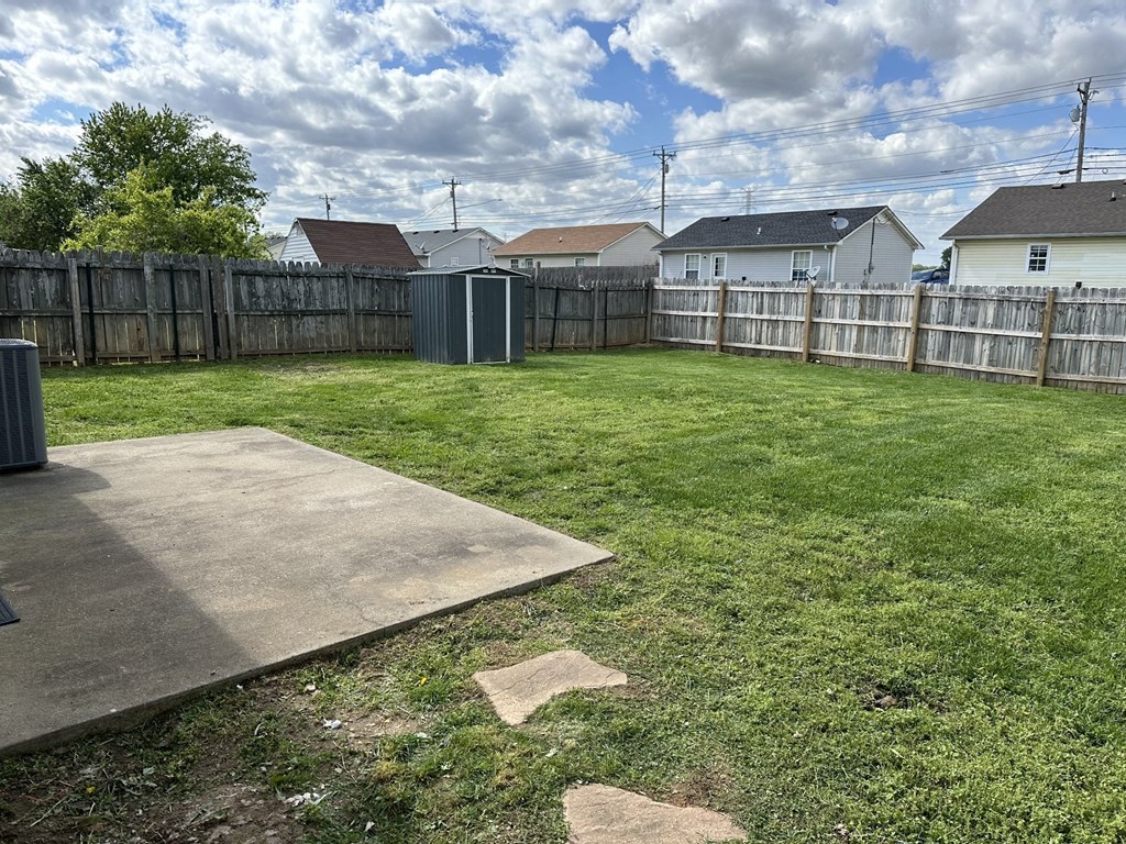 a backyard with a fence and a yard with grass