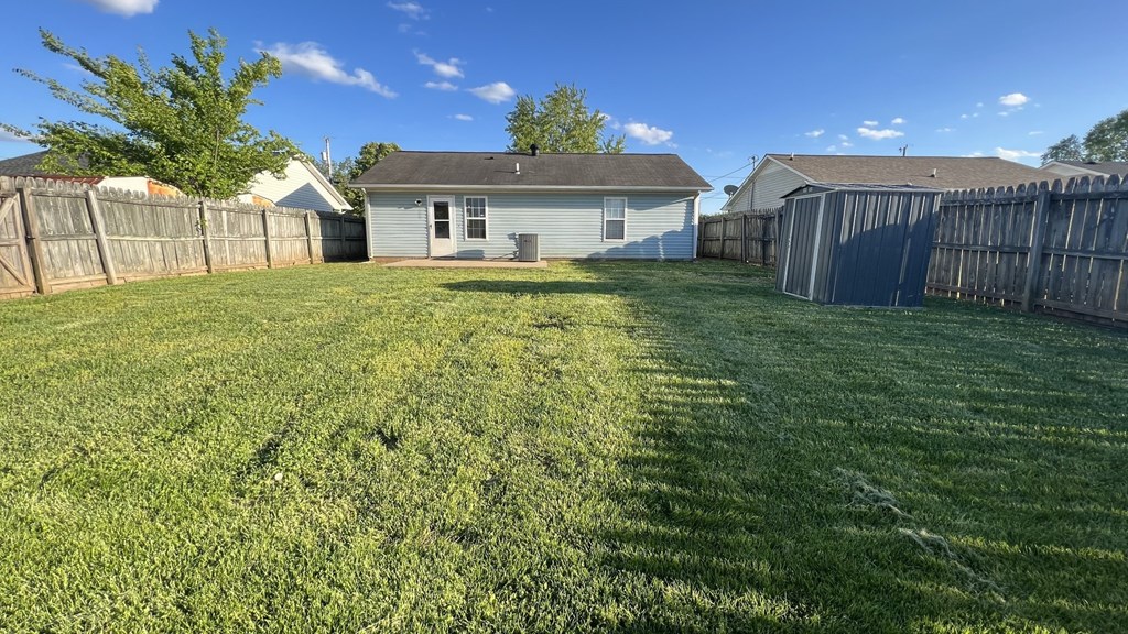 a backyard with a fence and a house
