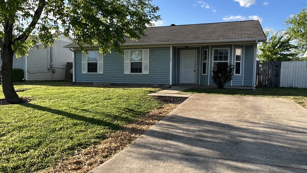 a blue house with a sidewalk in front of it
