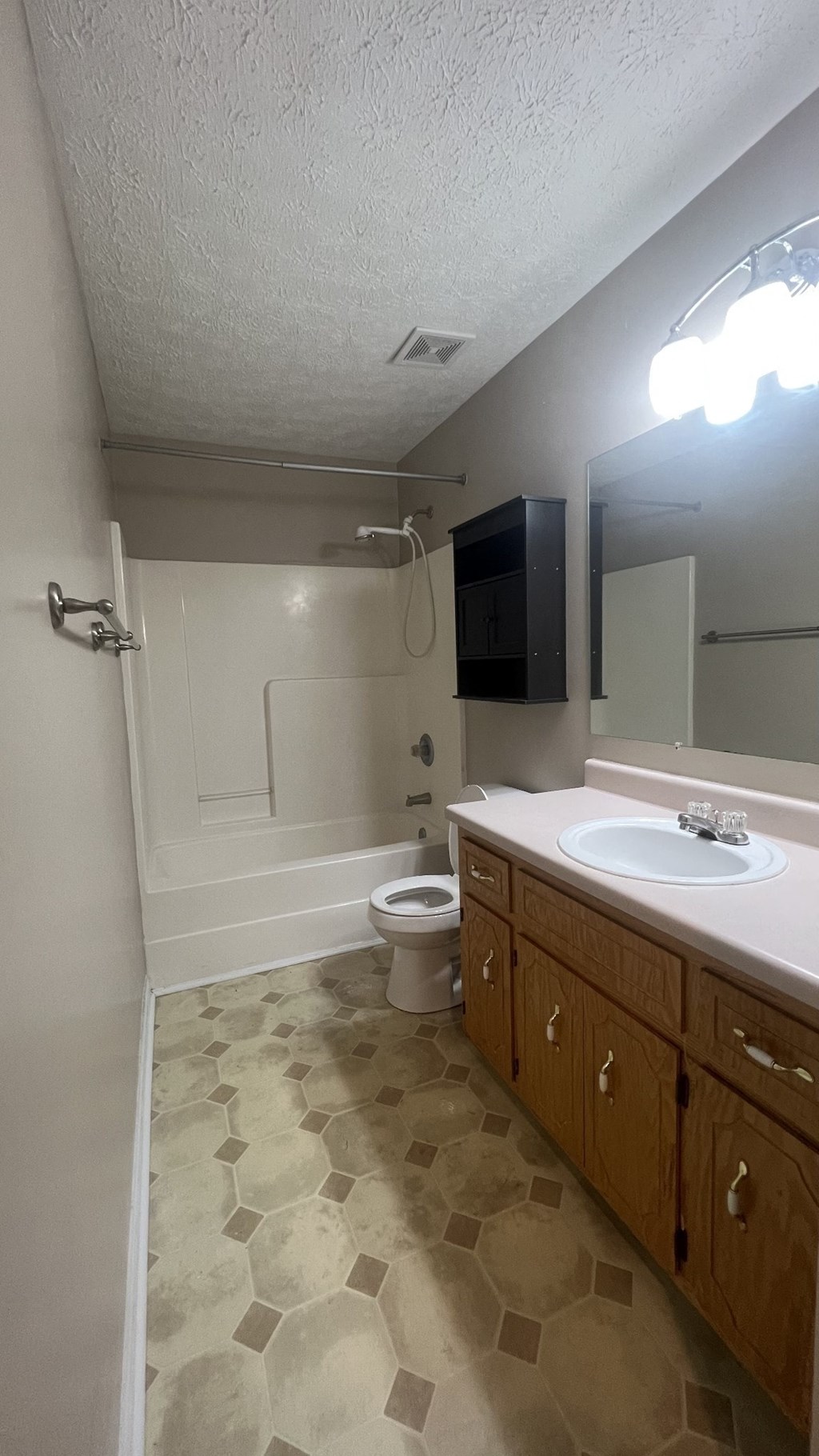 a bathroom with a sink and a toilet and a bath tub