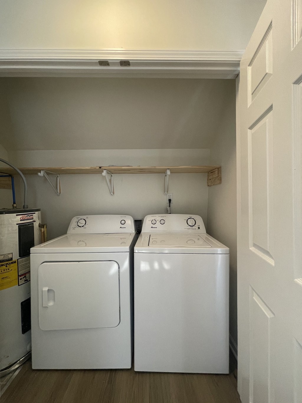 two washers and dryers in the laundry room of a home