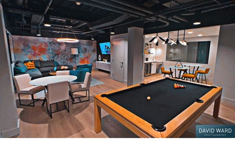 a game room with a pool table and tables