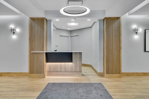 a lobby with a reception desk and a rug