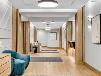 a lobby with a blue chair and a couch