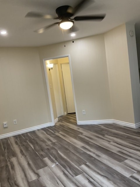 A room with a ceiling fan and light fixture.