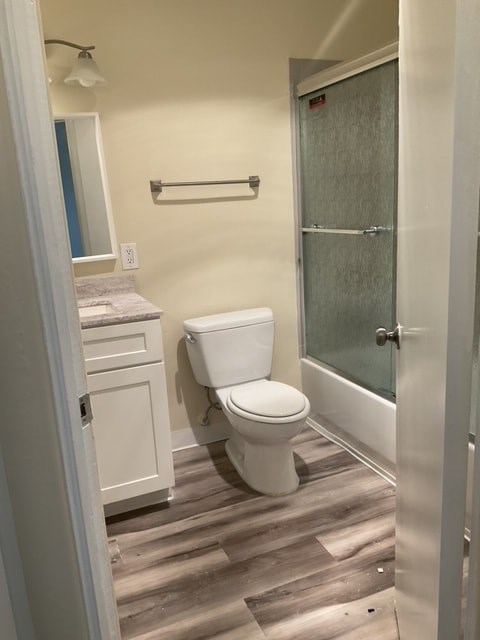 A white toilet in a bathroom with a glass shower door.