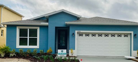 a blue house with a white garage door