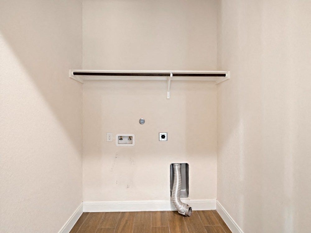 a room with a radiator and a white wall and a pipe