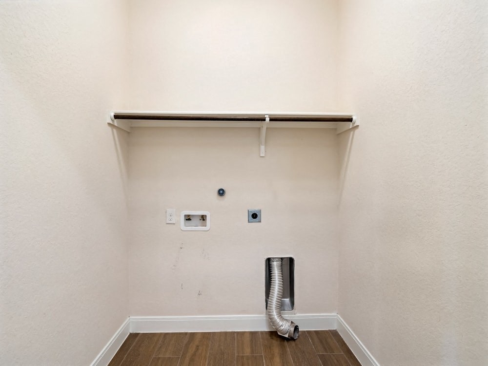 a garage door is open in a white room with a heater in the corner