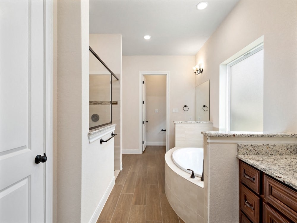 a bathroom with a tub and a sink and a mirror