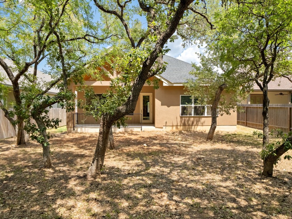 the front yard of a house with trees