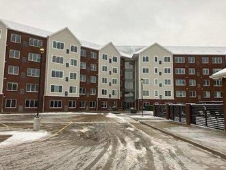 a large apartment building in the snow