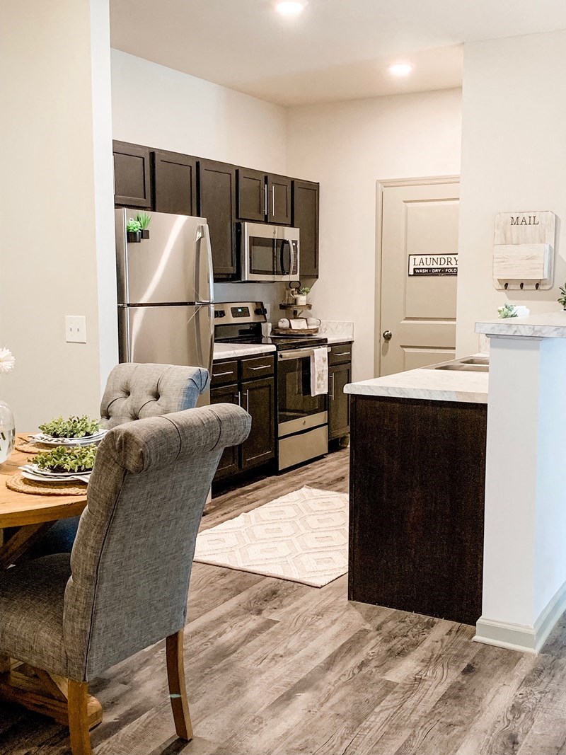 a kitchen with stainless steel appliances and a dining table
