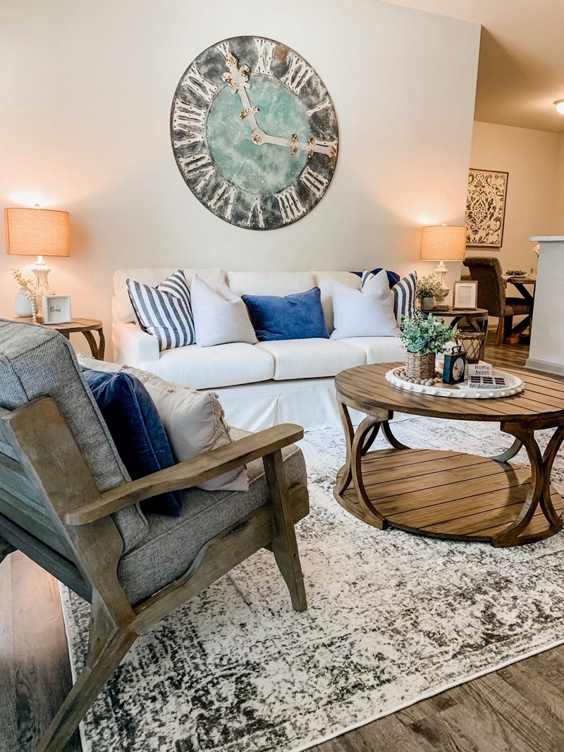 a living room with a couch and a clock on the wall
