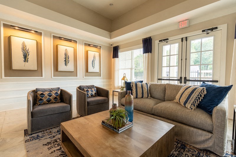 a living room with couches and chairs and a coffee table