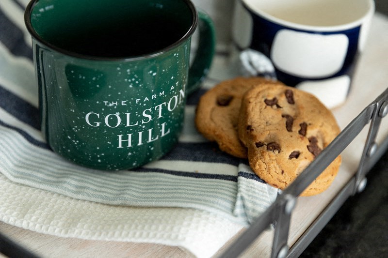 a plate of cookies and a coffee mug on a table