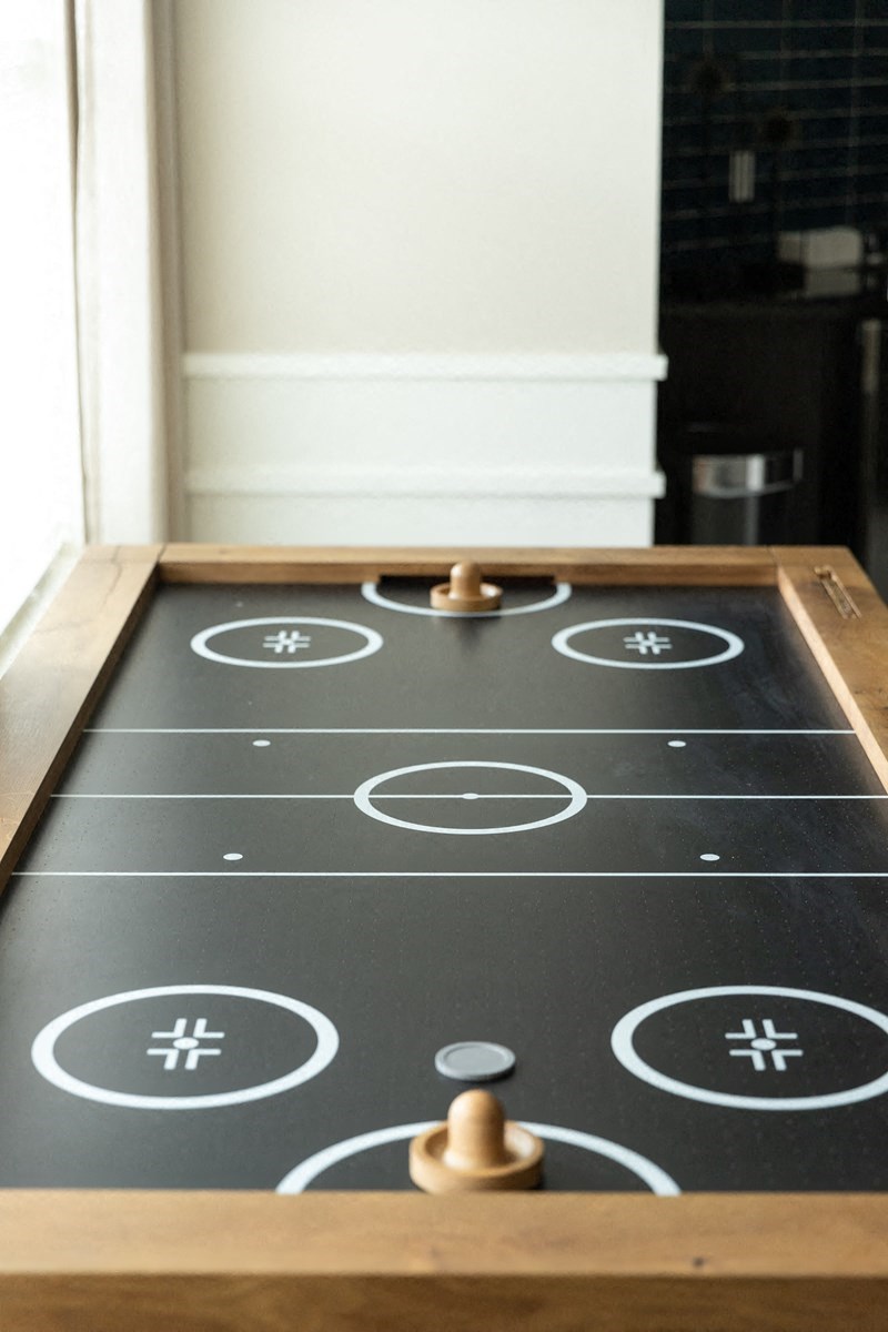a close up of a play board with two wooden balls on it
