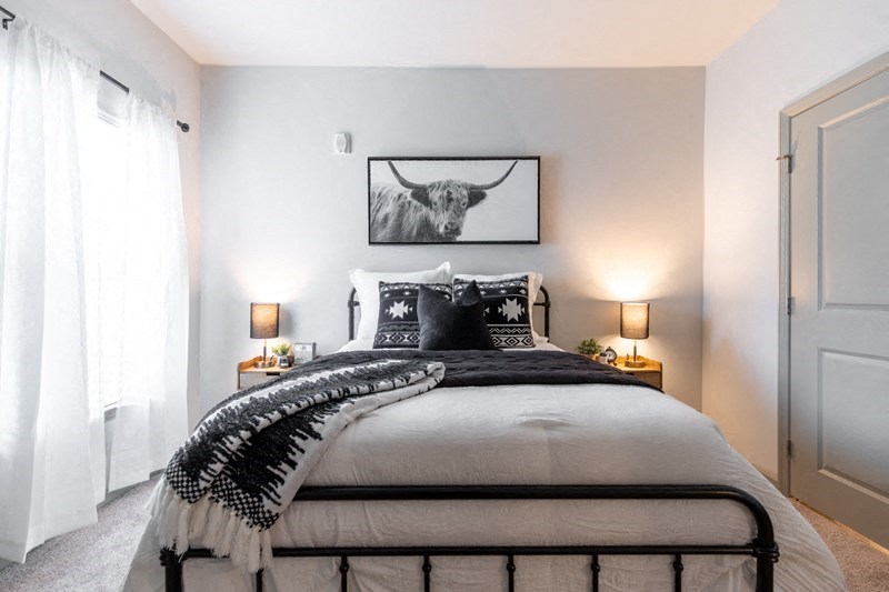a bedroom with a bed and a picture of a bull
