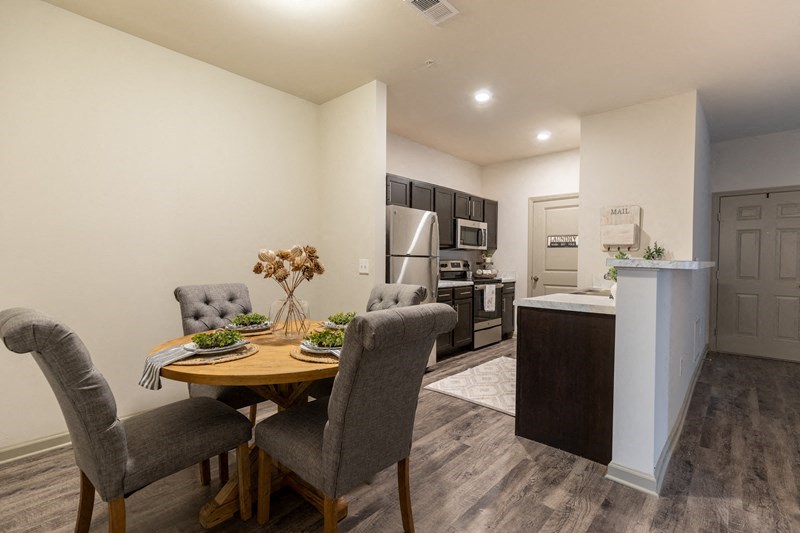 a kitchen and dining room with a table and chairs
