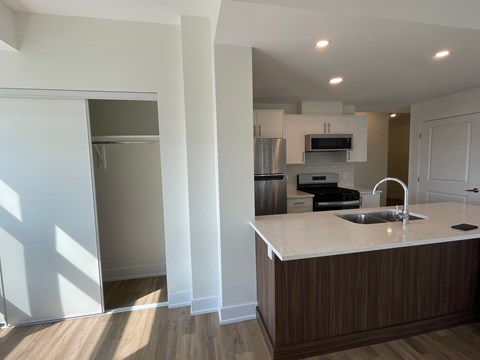 A kitchen with a sink and a refrigerator.