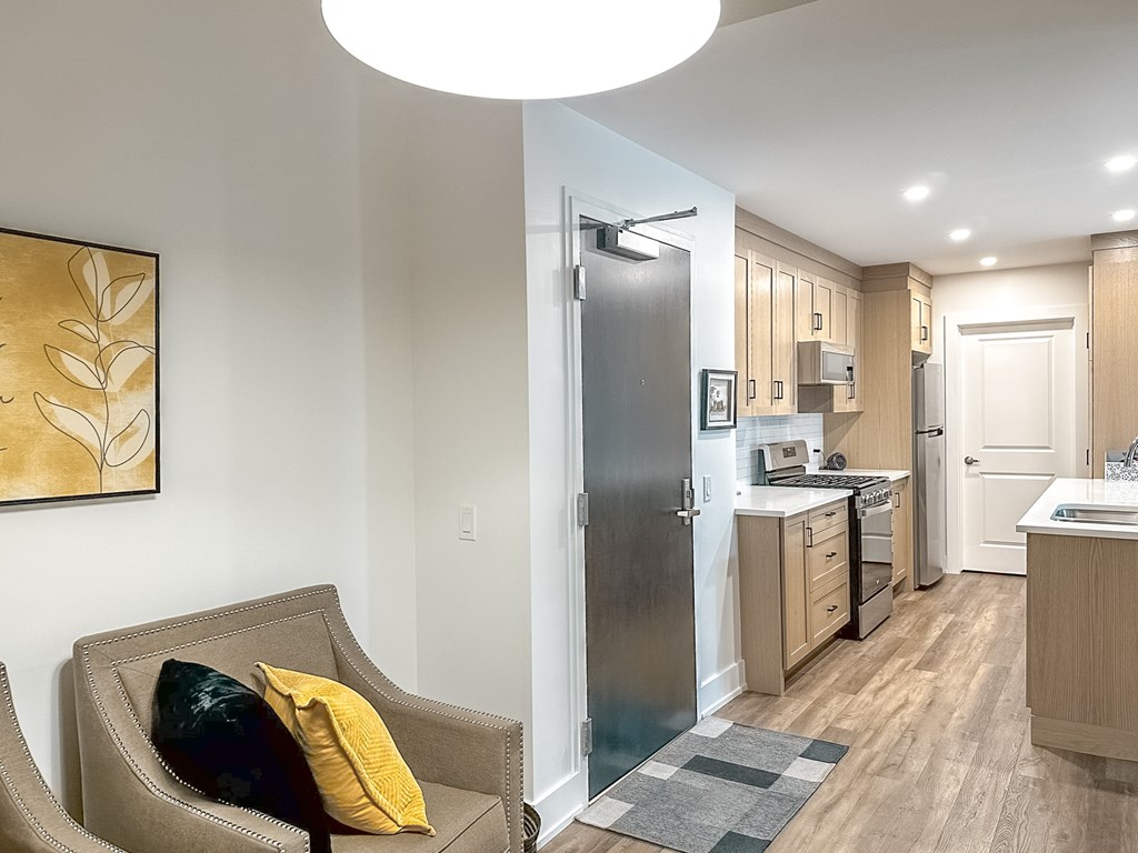 A modern kitchen with a refrigerator, sink, and cabinets.