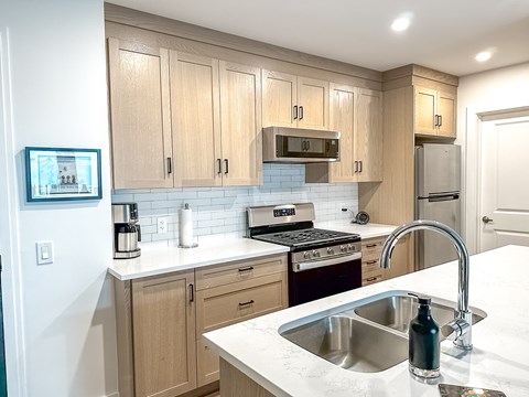 A kitchen with wooden cabinets and a white countertop.