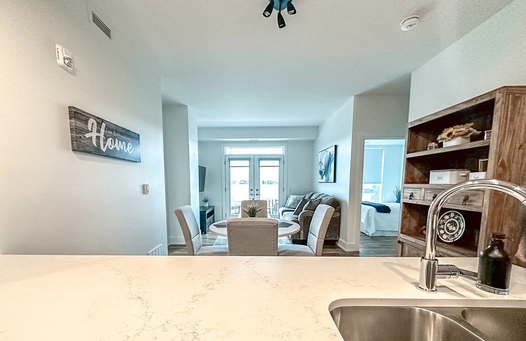 A kitchen with a sink and a sign on the wall.