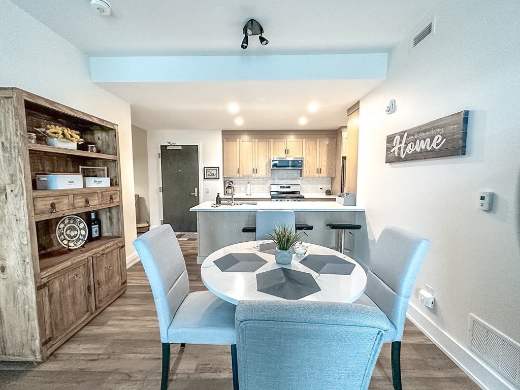 A modern kitchen with a dining table and chairs.