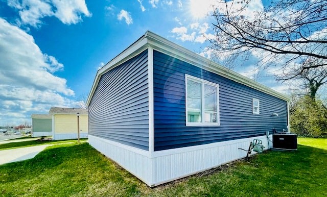 the exterior of a blue house with a yard and a white fence