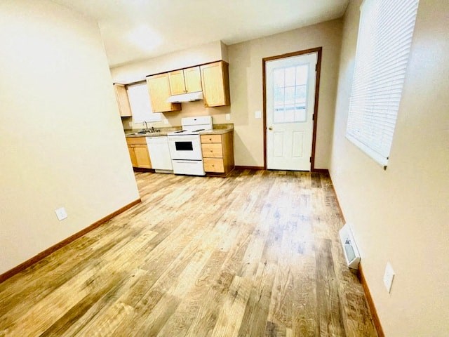a kitchen and living room with a wood floor
